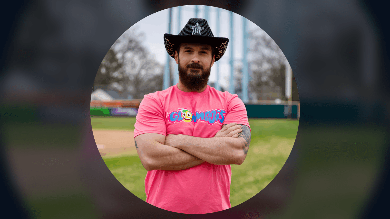 Ray Ortega wearing a Glowmojis shirt and cowboy hat on a baseball field