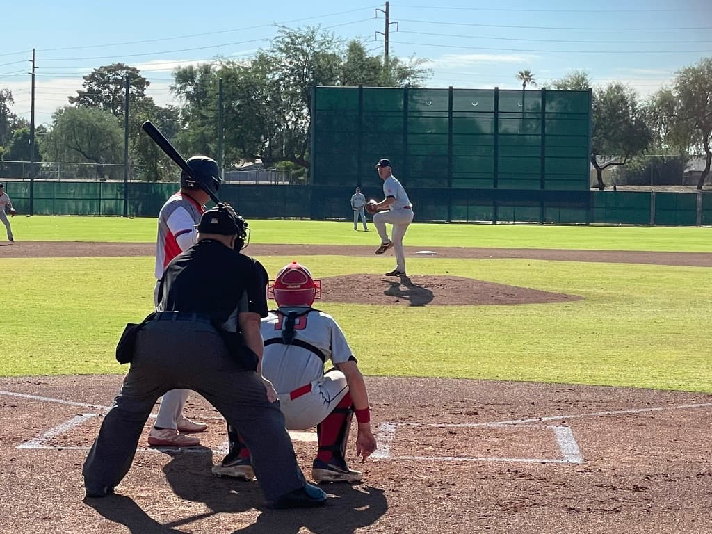 An adult baseball game with a batter at the plate